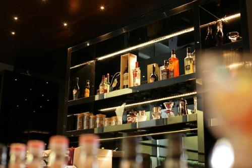 a shelf filled with lots of bottles of alcohol at Platinum Hotel & Convention Hall Balikpapan in Balikpapan