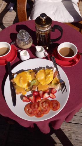 a plate of food with fruit on a table at Tulip Resort Pai in Pai