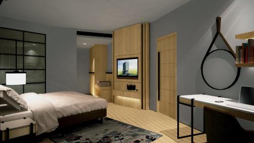 a bedroom with a bed and a desk and a television at Novotel Karawang in Karawang