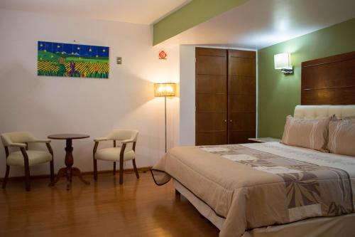 Un pat sau paturi într-o cameră la Hotel Malinalli