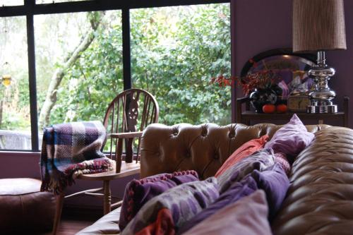 a living room with a couch and a large window at Waitapu Springs B&B in Takaka