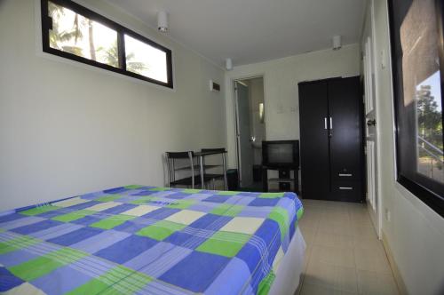 a bedroom with a bed and a room with a chair at Casa Miguel Resort in San Bartolome