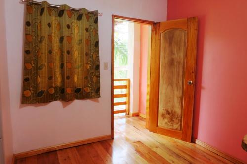 an empty room with a door and a curtain at Michelina Princess Guest House in Loboc
