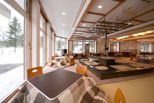 a large room with a table and chairs at Rosenheim Hakuba in Hakuba