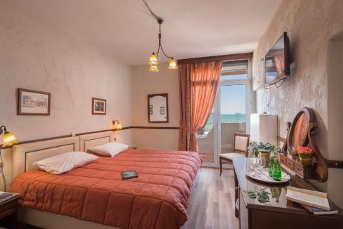 Postel nebo postele na pokoji v ubytování Jolly Hotel