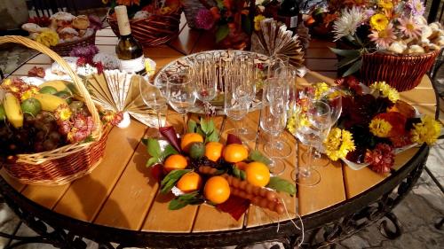a table with fruits and vegetables and wine glasses at Imereti Health Resort in Tskaltubo