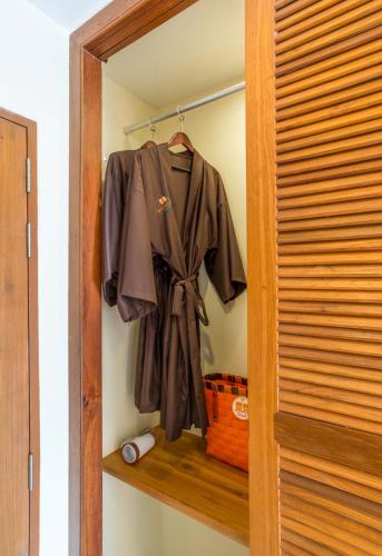 a closet with a robe on a wooden shelf at Srisuksant Resort in Ao Nang Beach