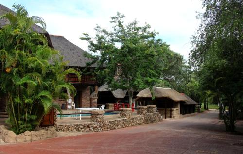 a house with a swimming pool in front of it at Jabula Kruger Safari Lodge in Marloth Park