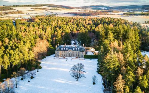 an aerial view of a house in a forest at Blervie House in Forres
