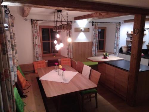 a kitchen and dining room with a table and chairs at Ferienwohnung Maringer in Ungenach