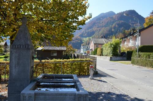 a stone bench sitting on the side of a street at Jungfrau Family Holiday Home in Matten