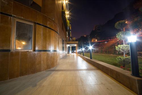 an empty sidewalk in a city at night at Le Caravelle Beirut in Beirut