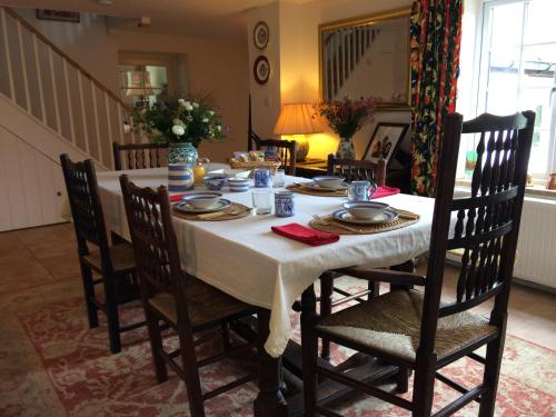 a dining room table with a white table cloth on it at Meadowland Farm in Dolton