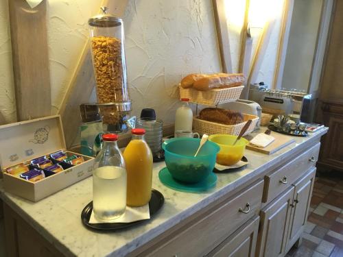a counter with bottles of milk and other items on it at Auberge Saint-Martin in Orchimont