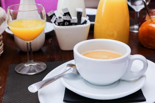 a cup of coffee on a table with a glass of orange juice at Terra Gasconha in Barbaste