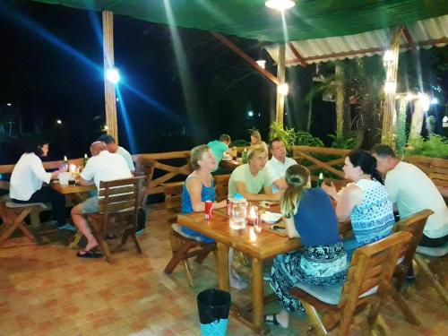 a group of people sitting at tables in a restaurant at Huan Chiang Dao Resort in Chiang Dao