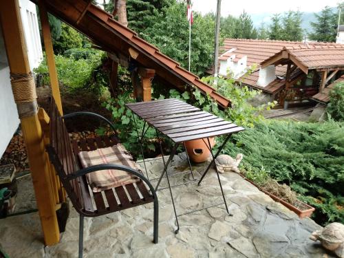a picnic table and a chair on a patio at Farma Zdrowia in Znamirowice