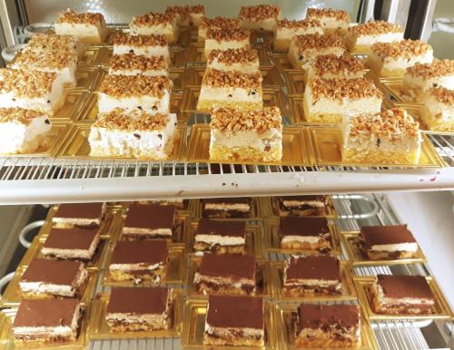 a display case filled with lots of chocolate desserts at Palazzo Bove in Galatone