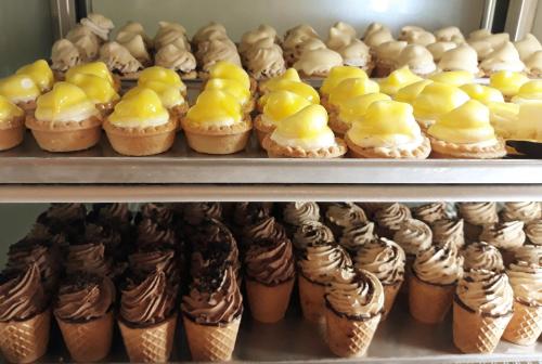 a bunch of cupcakes and muffins on a shelf at Palazzo Bove in Galatone