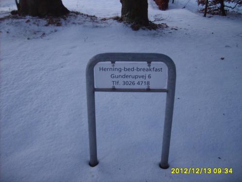 a sign in the snow in the snow at Herning Bed & Breakfast in Herning