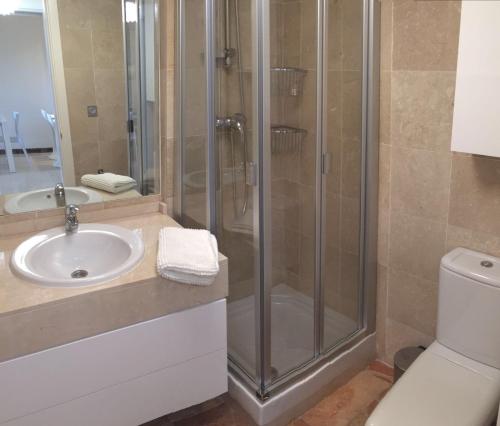 a bathroom with a shower and a sink at Modern Ground Floor Calanova Golf Apartment in La Cala de Mijas