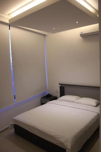 a bedroom with a large white bed in a room at Le Caravelle Beirut in Beirut