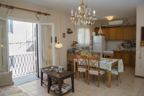 a kitchen and living room with a table and a dining room at Corfu Retreat in Corfu