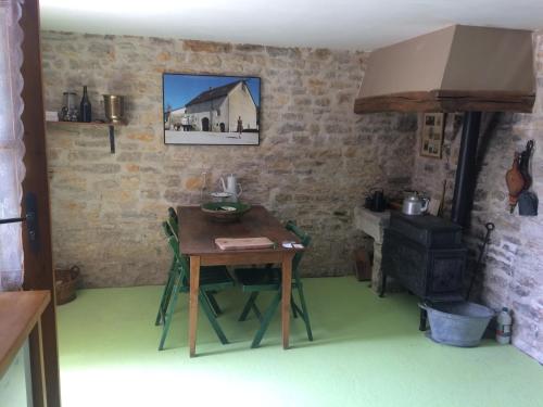 a room with a wooden table in a room at Gîte Chambre de la Tante Camille - Les Filles Tresy in Passenans