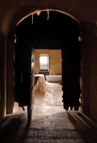 an entrance to a bathroom with a tub and a window at Sextantio Le Grotte Della Civita in Matera