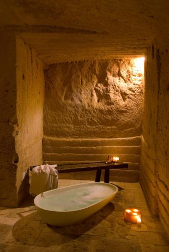 a bathroom with a bath tub in a cave at Sextantio Le Grotte Della Civita in Matera