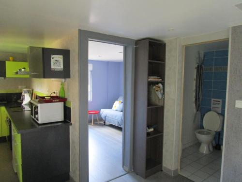 a kitchen with a sink and a room with a toilet at Gîte dans les Alpes Mancelles in Gesnes-le-Gandelin