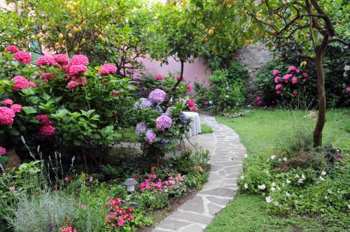 a garden with flowers and a stone path at Il Giardino Incantato in Monterosso al Mare