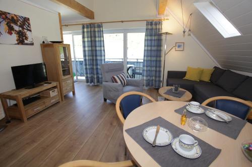 a living room with a table and a couch at Appartement Familie Ernst in Bruttig-Fankel