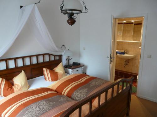 a bedroom with a large bed and a sink at Pension Wegerich in Erfurt