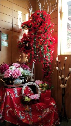 a table with a bunch of flowers on it at Taichung Xinshe Garden Life Homestay B&B in Xinshe