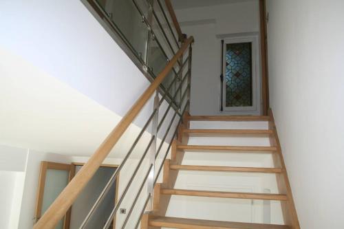 a staircase in a house with a stained glass window at Les terres in Chaponost