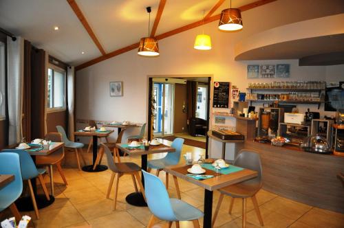 ein Restaurant mit Tischen und Stühlen und einer Theke in der Unterkunft Brit Hotel Azur in Saint-André-de-la-Marche