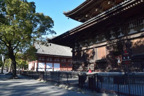 a building with a fence in front of it at Kyoto Shaw Inn in Kyoto