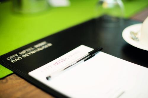 a pen sitting on top of a book on a table at City Hotel Bosse in Bad Oeynhausen