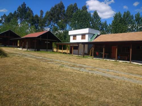 a group of buildings on a dirt road at Cabañas Tornagaleones Villarrica in Villarrica