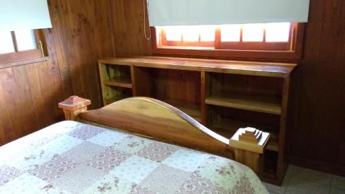 a small bedroom with a bed and a window at Cabañas Tornagaleones Villarrica in Villarrica