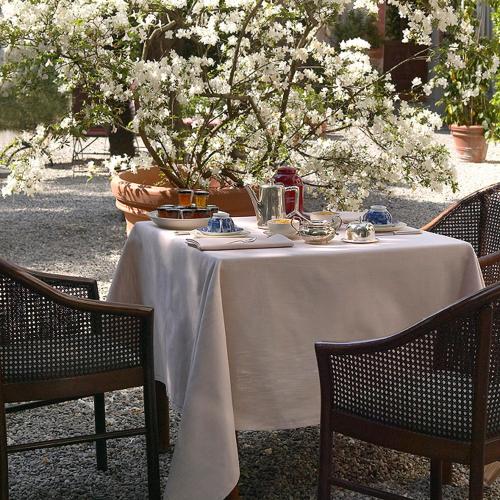 a table with a white table cloth on top of it at Hotel Locanda Dei Mai Intees in Azzate