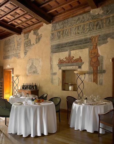 a dining room with two tables with white table cloth at Hotel Locanda Dei Mai Intees in Azzate