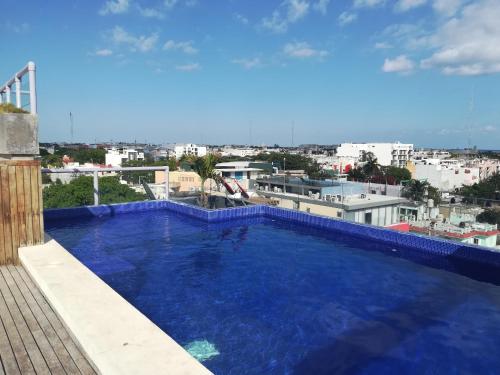 a large swimming pool on the roof of a building at Iris Studios & Apartments in Playa del Carmen