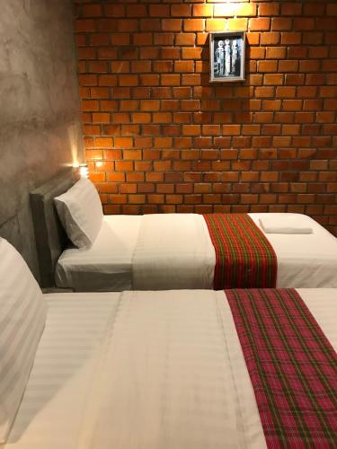 Postel nebo postele na pokoji v ubytování Khum Lanna Boutique Hotel