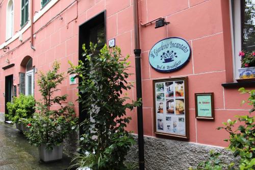 a pink building with a sign on the side of it at Il Giardino Incantato in Monterosso al Mare