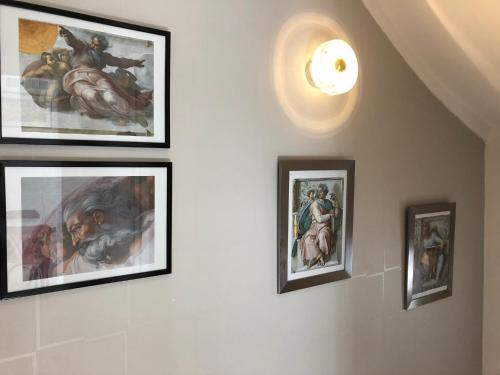 a group of framed paintings on a wall at Villa Mary in Amboise