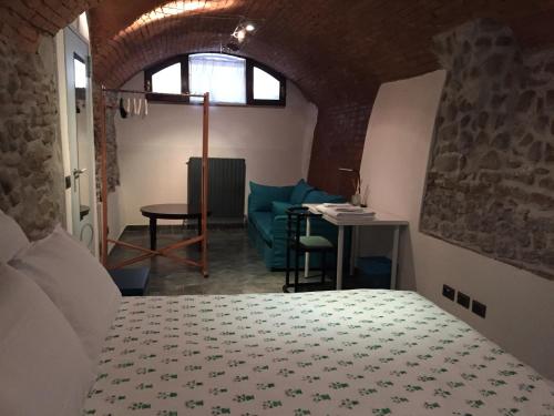 a bedroom with a bed and a table and a chair at All' Ombra del Portico in Bologna