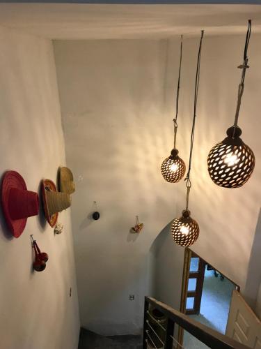 a room with three lights hanging from the wall at El Caite Hostel in Granada