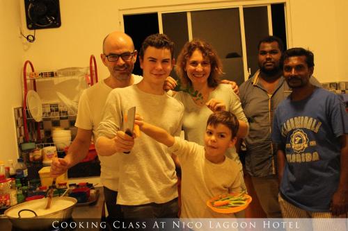 a group of people posing for a picture in a kitchen at Nico Lagoon Hotel in Negombo